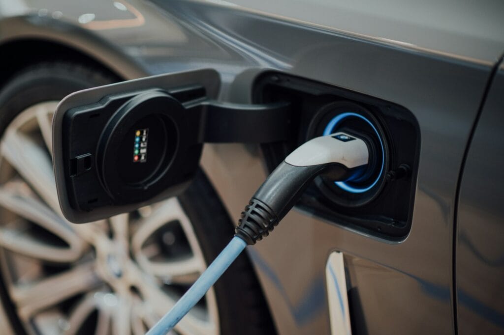 Cable de recarga conectado a la toma de un coche eléctrico